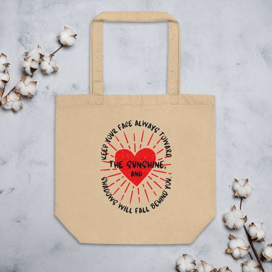 Keep your face always toward the sunshine, and shadows will fall behind you. Eco Tote Bag